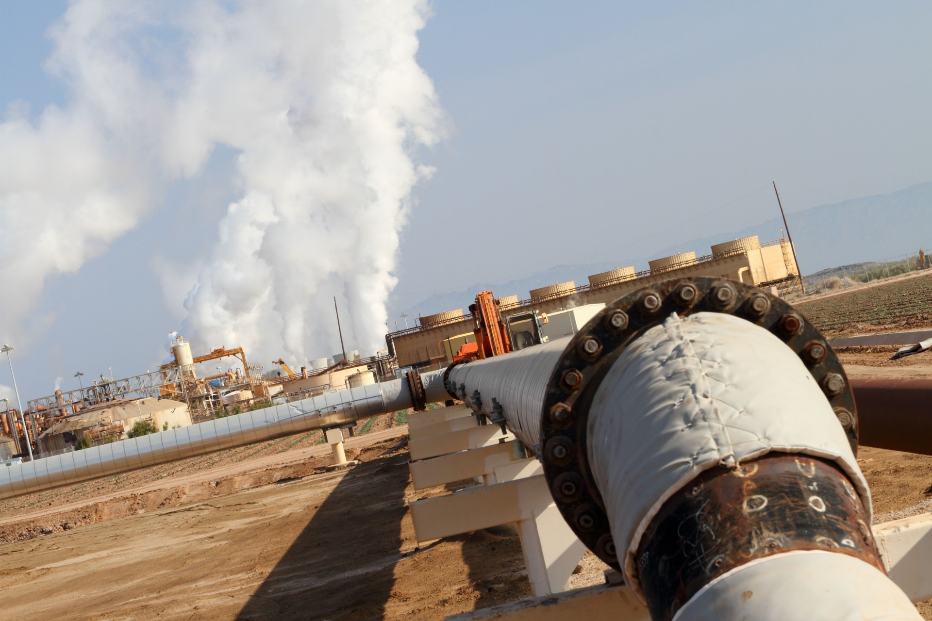 Geothermal Power Plant With Pipe in Foreground Angle