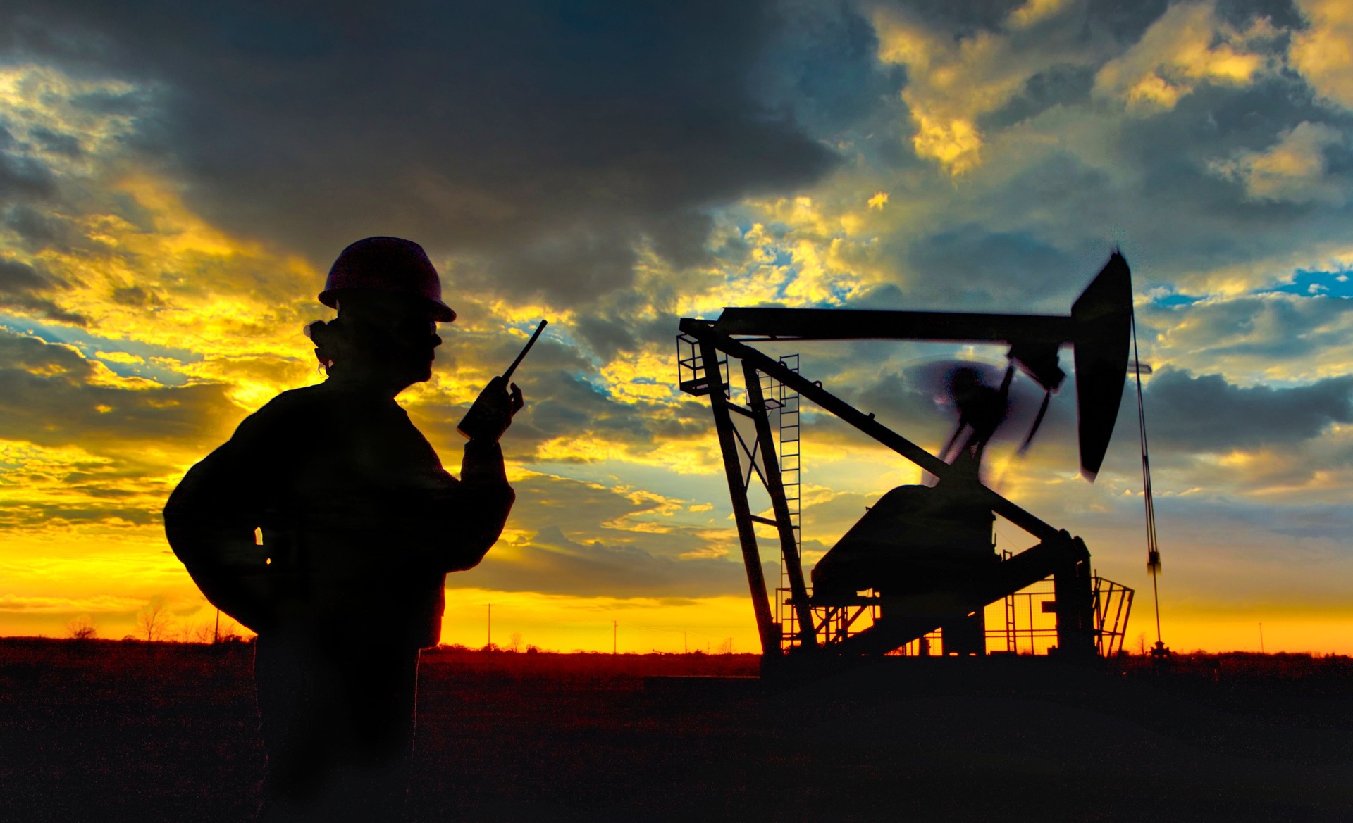 Silhouette of Oilfield Worker at Sunset