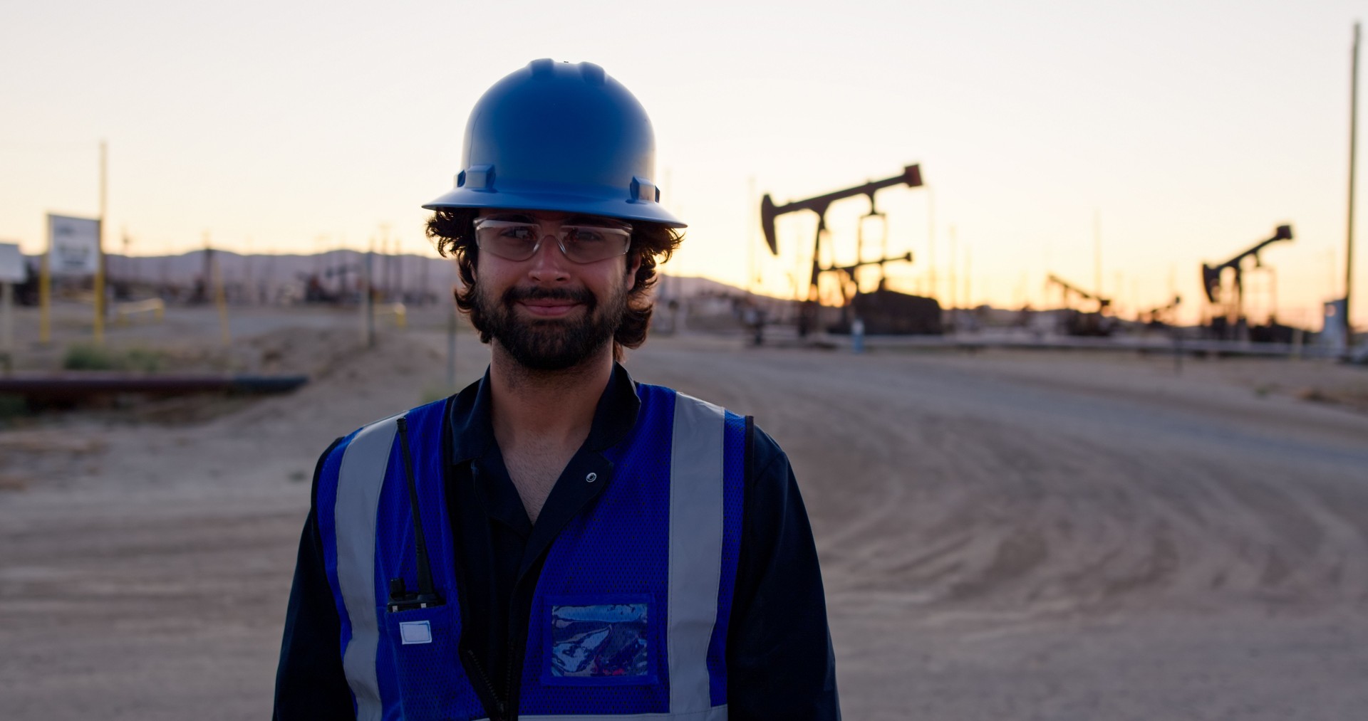 Indian Oilfield Worker Smiling at the Camera at Sunset